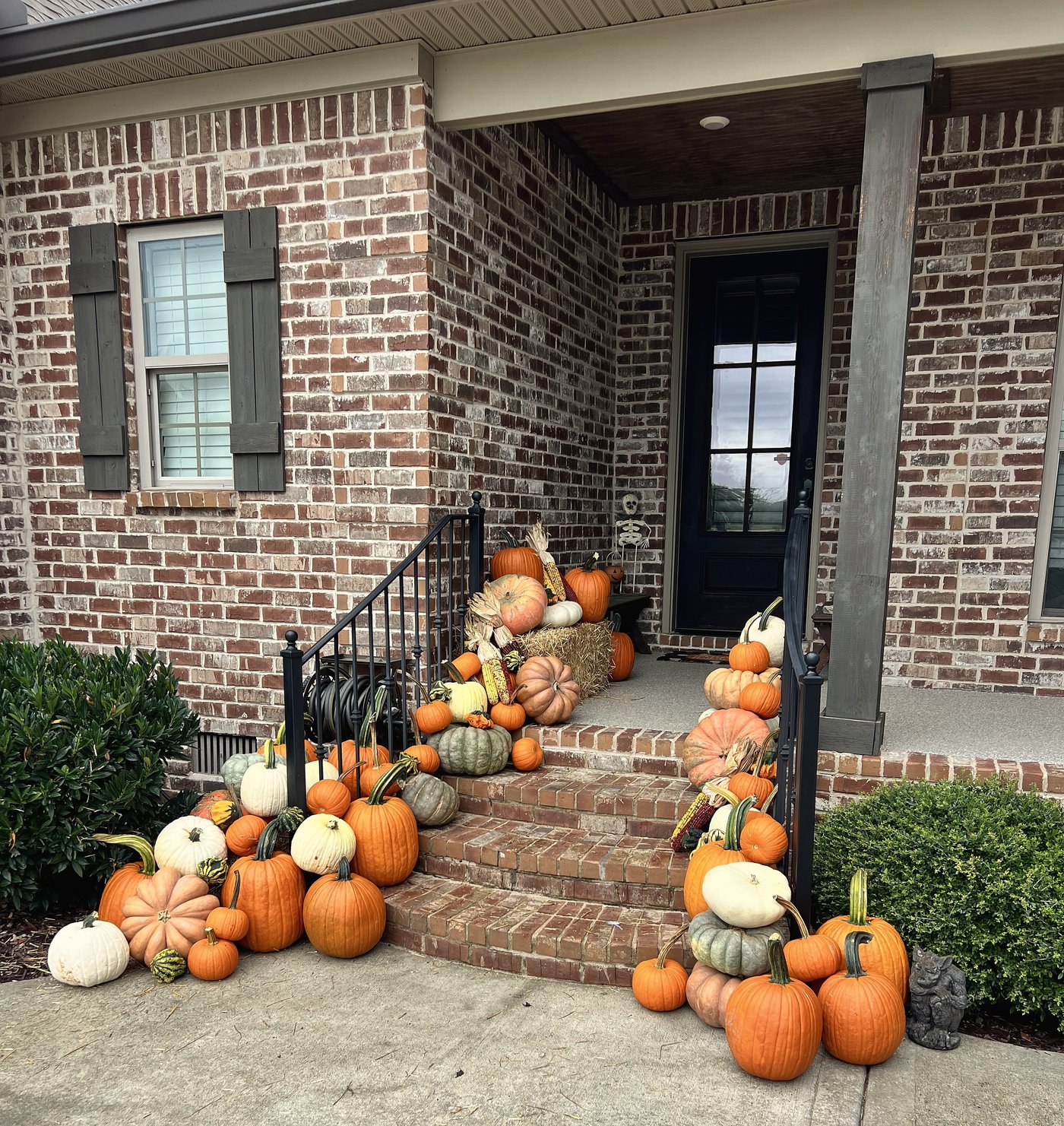 Cornucopia abundant pumpkin porch display on brick steps